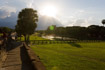 Late evening view down the causeway leading to Angkor Wat with a sunburst coming from behind a bank of clouds