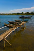 A simple jetty made from a few planks and bamboo juts into the river at Hoi An, Vietnam